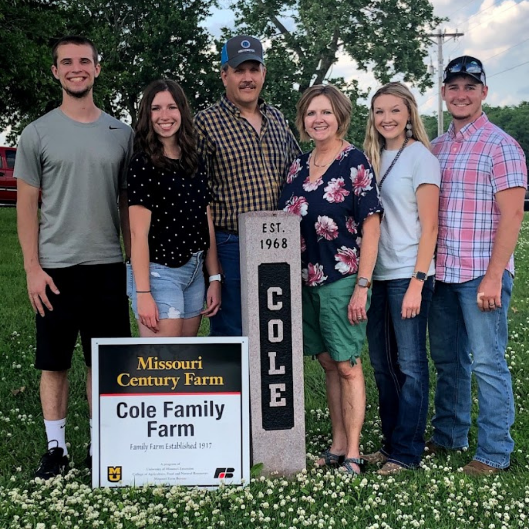 Brother-in-law Sam Fields, sister Lauren Fields, Dad Rodney Cole, Mom Geneva Cole, Korinne and Brian with their century farm sign and her grandpa's yard marker.